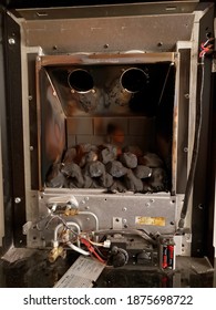 BRAY, CO. WICKLOW, IRELAND - SEPTEMBER 12, 2020: Inside Of The Home Gas Fireplace, With Removed Covering Glass. Dirty Fireplace Before Annual Cleaning.