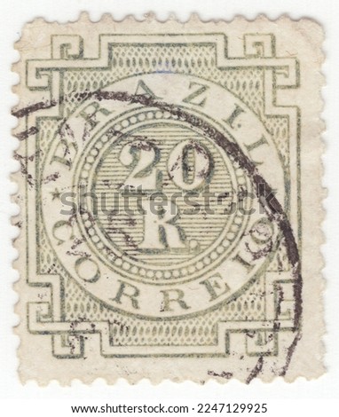 BRAZIL - 1884: An 20 reis olive-green postage stamp depicting Numeral and geometry ornament. Brazil is the largest country in both South and Latin America