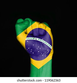 Brazil Flag On Fist Over Black Background. Symbol Of Strength.