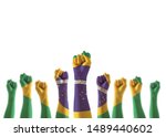 Brazil flag on people hands with clenched fists raising up for labor day national holiday celebration and stay strong for Brazilian power isolated on white background (clipping path)