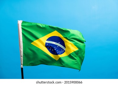 Brazil Flag Waving On Blue Background.