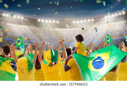 Brazil football supporter on stadium. Brazilian fans on soccer pitch watching team play. Group of supporters with flag and national jersey cheering for Brazil. Championship game. - Shutterstock ID 2177436111