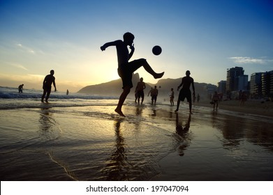 Brazil Kick-ups Sunset Silhouettes Playing Altinho Futebol Beach Football With Soccer Ball Ipanema Beach Rio De Janeiro