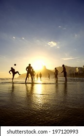 Brazil Kick-ups Sunset Silhouettes Playing Altinho Futebol Beach Football With Soccer Ball Ipanema Beach Rio De Janeiro