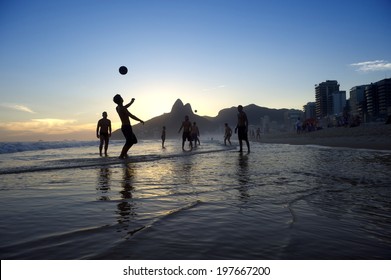 Brazil Kick-ups Sunset Silhouettes Playing Altinho Futebol Beach Football With Soccer Ball Ipanema Beach Rio De Janeiro