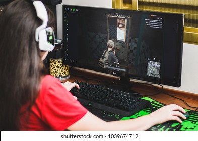 Brazil - March 01, 2018: Gamer girl seated in front of the computer playing PUBG.