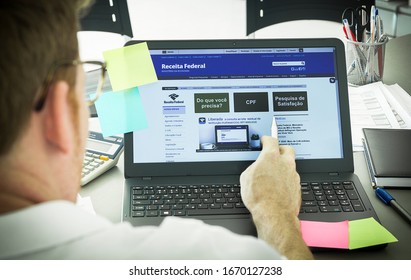 Brazil, March 11, 2020 - Brazilian Receita Federal Page Open On The Notebook Screen On Top Of An Office Bench