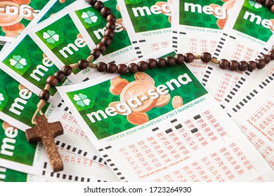 Brazil - May 2020: Various Mega Sena Tickets (National Lottery Of Brazil) And A Religious Cross Over It - Lottery Brand By Caixa Economica Brazilian Federal Bank