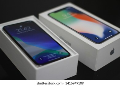 BRAZIL, MS, CAMPO GRANDE - JUNE 05, 2019: A Box Of A New IPhone X Being Opened With Wallpaper Of The New IOS 13