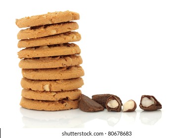 Brazil Nut Cookie Stack With Fresh Brazil Nuts Cracked Open To One Side, Isolated Over White Background.