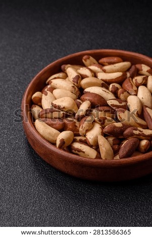 Brazil nuts, raw and shelled, are a source of selenium and a healthy food ingredient. Brazil nuts as a food background for your design