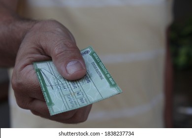 Brazil. October 21, 2020. Holding Brazilian Voter Registration Card (título Eleitoral) - Selective Focus