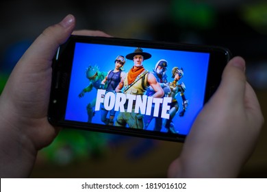 Brazil, São Paulo, September 18 2020: Child Holding Cell Phone With Fortnite Game - Epic Games