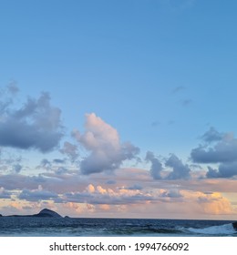 Brazil, Rio de Janeiro, Leblon, April 4, 2021: beatiful sunset at Leblon Beach, Rio de Janeiro. In this image you can see some clouds, a blue and orange sky and the sea.