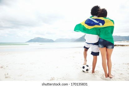 Brazil Soccer Fans Stand On Beach Together With Flag For World Cup With Ball