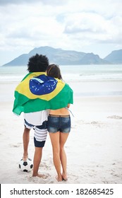 Brazil Soccer Fans Stand On Beach Together With Flag For World Cup With Ball