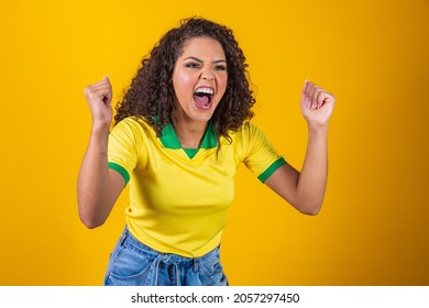 Brazil Supporter. Brazilian Curly Hair Woman Fan Celebrating On Soccer, Football Match On Yellow Background. Brazil Colors.