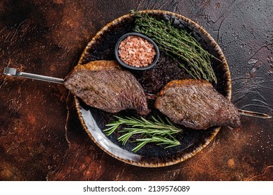 Brazilian BBQ - Grilled Dry Aged Picanha Beef Steak With Herbs. Dark Background. Top View.