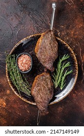 Brazilian BBQ - Grilled Dry Aged Picanha Beef Steak With Herbs. Dark Background. Top View.