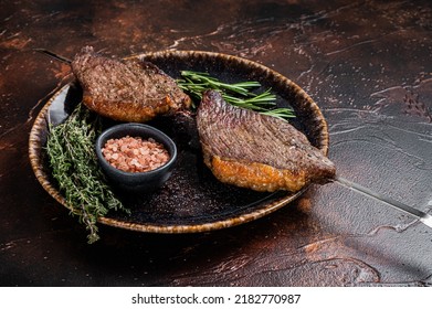 Brazilian BBQ - Grilled Dry Aged Picanha Beef Steak With Herbs. Dark Background. Top View.