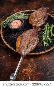 Brazilian BBQ - Grilled Dry Aged Picanha Beef Steak With Herbs. Dark Background. Top View.