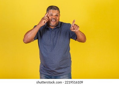 Brazilian Black Man, Adult Pointing Something Distant With His Finger, Surprised.