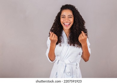 Brazilian Black Woman, Wearing Bathrobe And Towel. Curly Hair, Spa, Beauty Center, Hair Care. Showing Hair. Curls.