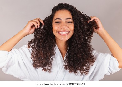 Brazilian Black Woman, Wearing Bathrobe And Towel. Curly Hair, Spa, Beauty Center, Hair Care. Showing Hair. Curls.