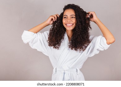 Brazilian Black Woman, Wearing Bathrobe And Towel. Curly Hair, Spa, Beauty Center, Hair Care. Showing Hair. Curls.