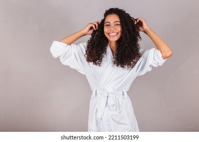 Brazilian Black Woman, Wearing Bathrobe And Towel. Curly Hair, Spa, Beauty Center, Hair Care. Showing Hair. Curls.