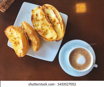 Brazilian breakfast. Capuccino cup and toasted bread with butte