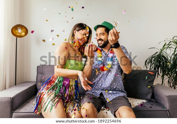 Brazilian\
Carnival. Couple celebrating carnival at\
home