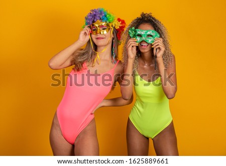 Brazilian Carnival. Two young women in costume enjoying the carnival party. Friends.