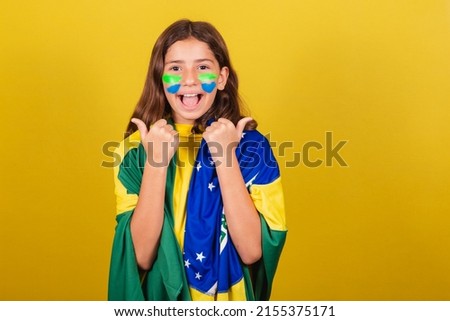 brazilian, caucasian child, soccer fan, thumb up. approving, approval, affirmative. World Cup. Olympics.