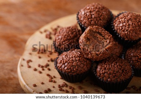 Brazilian chocolate truffle bonbon brigadeiro on wooden table. Selective focus