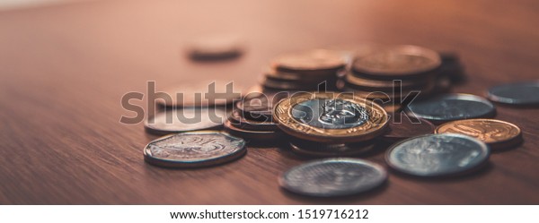 Brazilian coins\
background. Real coins and cent coins. Money from Brazil. Coins of\
Real, Brazilian\
currency.