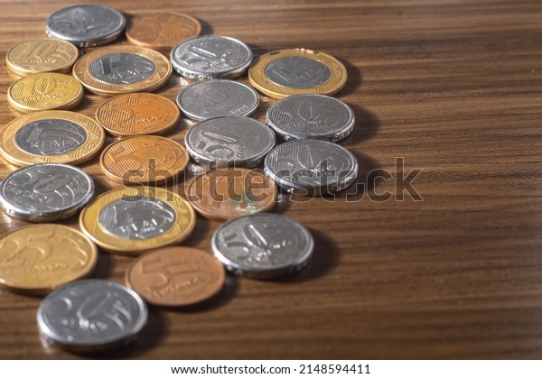 Brazilian coins\
background. Real coins and cent coins. Money from Brazil. Coins of\
Real, Brazilian\
currency..