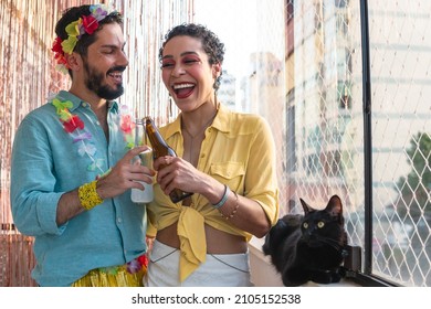 Brazilian couple celebrating Carnival at home. Man and woman toasting during Carnaval in Brazil. - Shutterstock ID 2105152538
