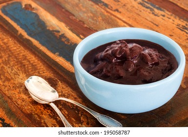 Brazilian Dessert Acai In Blue Bowl With Spoon On Wooden Table Close. Selective Focus