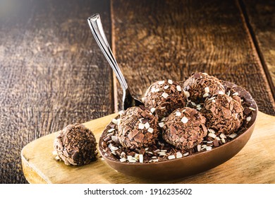 brazilian easter dessert, chocolate egg with cream filling, brazilian brigadier bonbons, biscuit and sugar, called a spoon egg