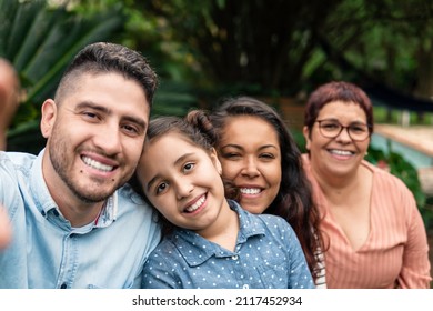 Brazilian Family Generations Looking At Camera And Smiling For Selfie Outside In The Garden