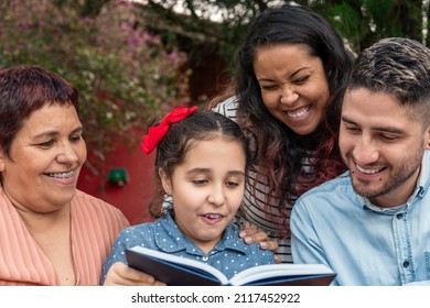 brazilian family generations reading book together in table outside - Powered by Shutterstock