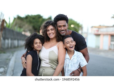 Brazilian family posing for photo looking at camera. Father, wife and children together - Shutterstock ID 1968592456
