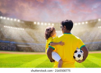 Brazilian father and son play football. Brazil fans watch match. Dad and little boy play soccer. Young active family enjoy sunny summer day outdoor. Healthy sport for kids. Football game club.