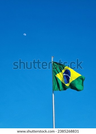 Brazilian flag and moon in a Sunny day 
