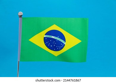 Brazilian Flag Waving On Blue Background.