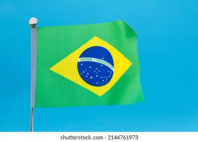 Brazilian Flag Waving On Blue Background.