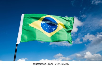 Brazilian Flag Waving On Blue Sky