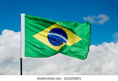 Brazilian Flag Waving On Blue Sky