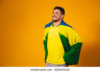 Brazilian football fan emotions: celebrating, excited, happy. Supporter of Brazil national soccer team is cheering. - Powered by Shutterstock